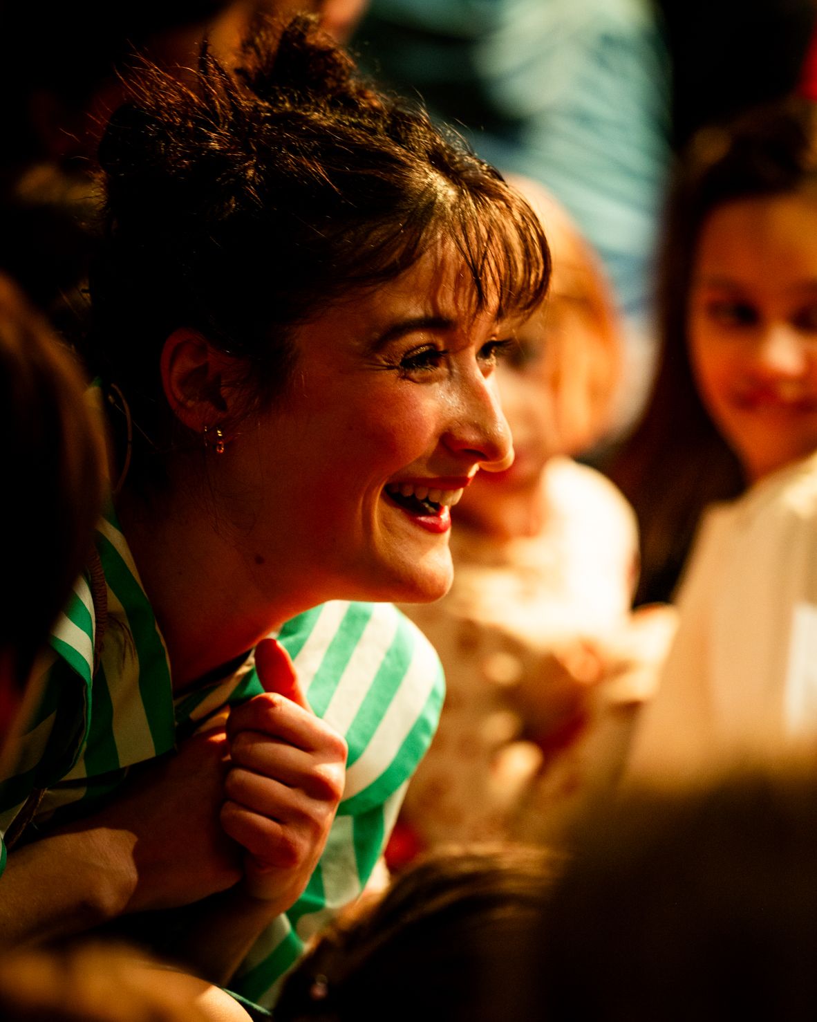 A young woman laughs with delight.
