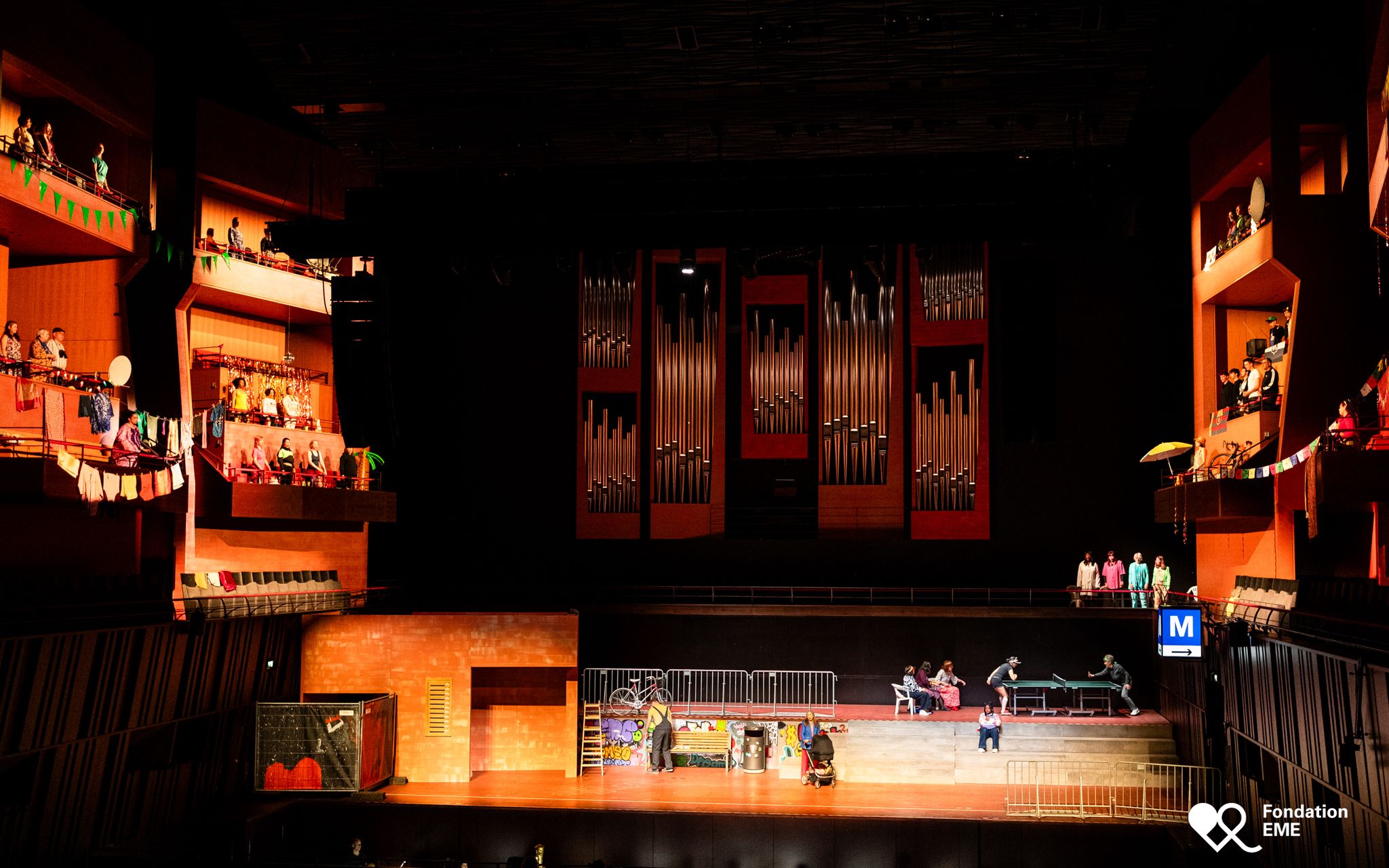 The stage of the Philharmonie Luxembourg with the organ, warmly lit.